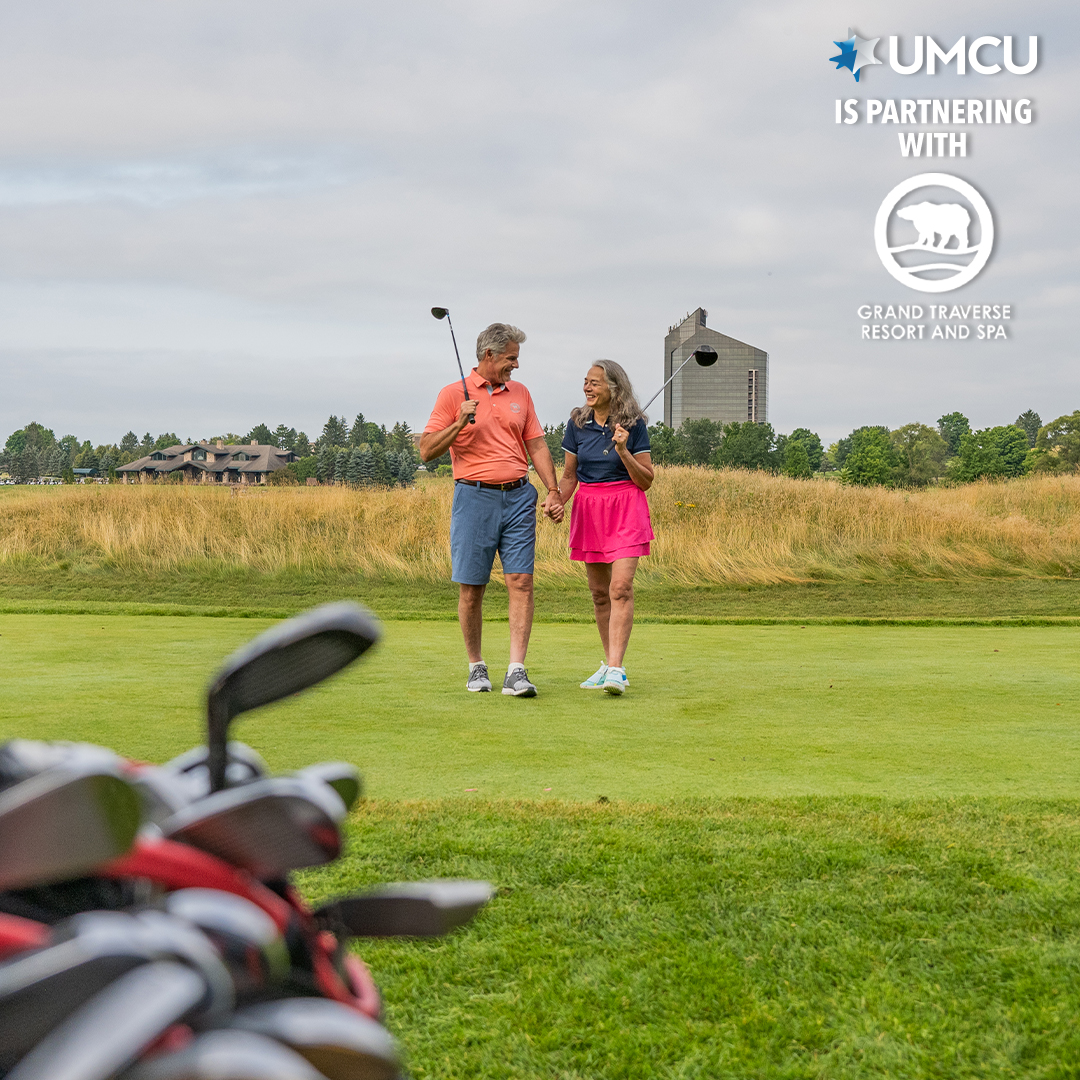 landscape view of couple golfing at Grand Traverse Resort