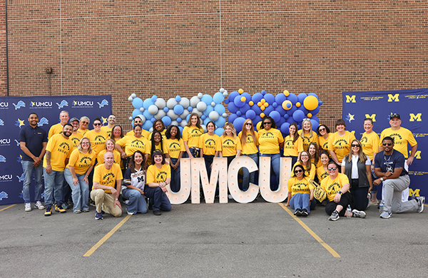 Team UMCU gathers for a photo at Touch Down Tailgate