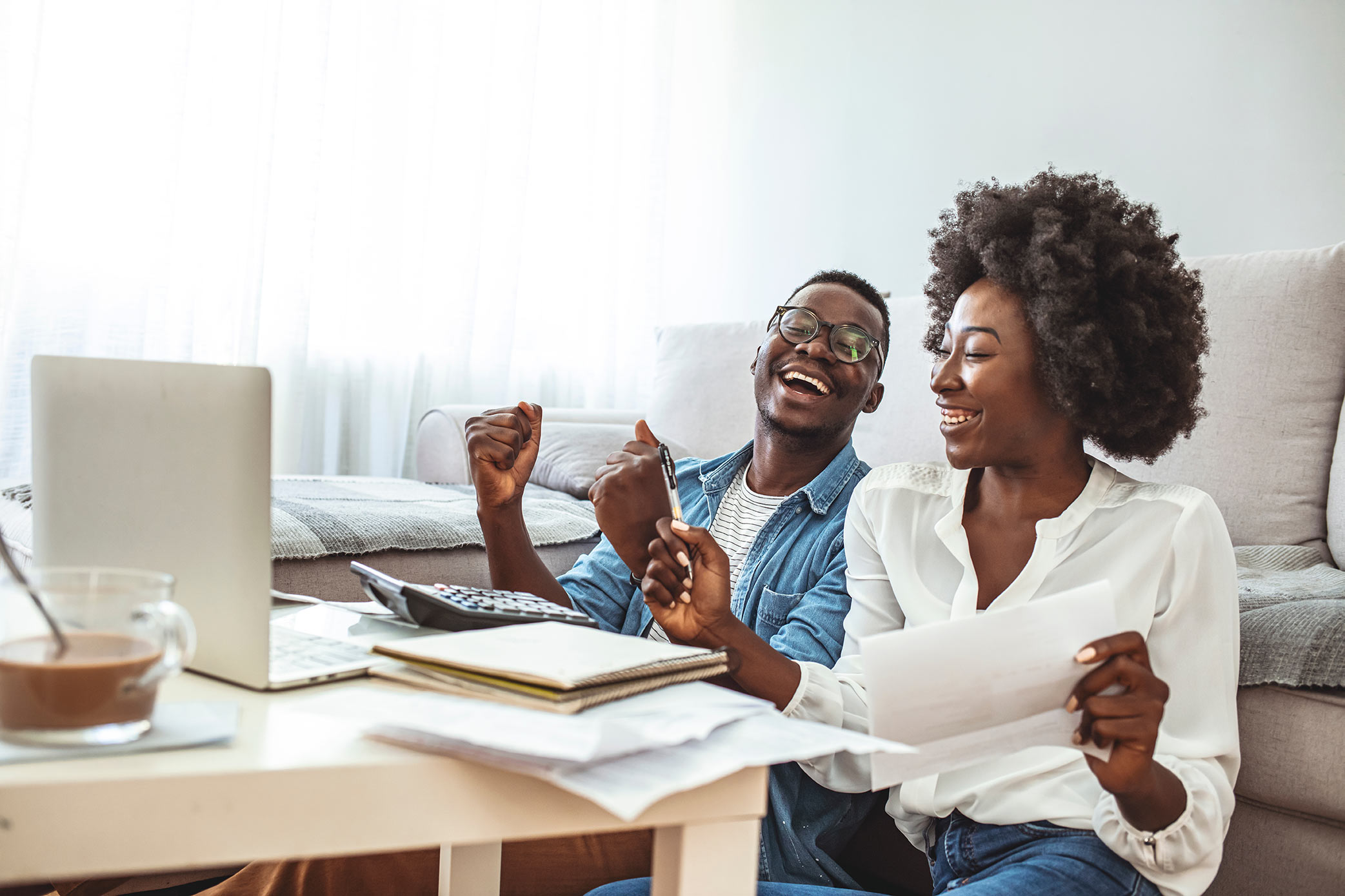 couple sitting together at table with computer