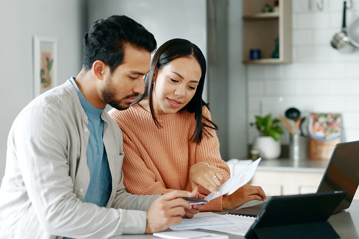 couple seated at computer doing paperwork